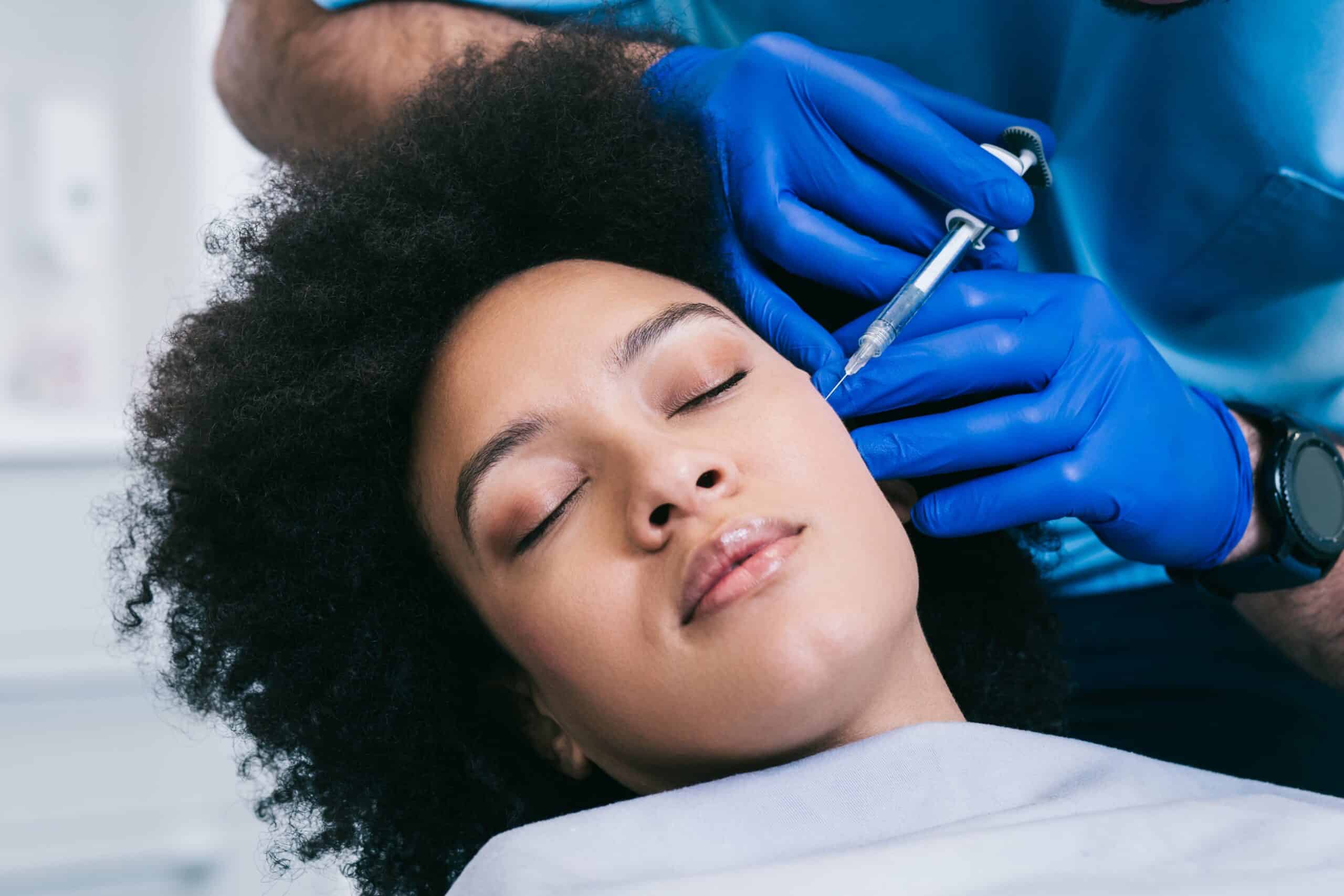 Young African Woman Getting Filler Injection | The Cosmetic Clinic in Greenwich, CT