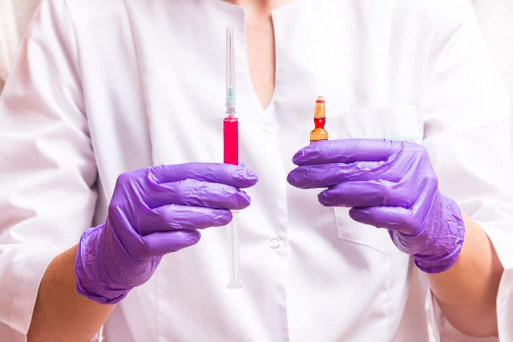 Woman hands holding syringe ampoule - Vitamin Shots | The Cosmetic Clinic in Greenwich, CT