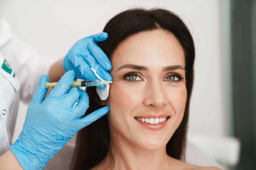 Beautiful woman getting Botox injection in the cosmetology salon. | The Cosmetic Clinic in Greenwich, CT